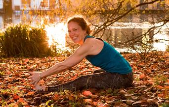 Seated forward bend yoga pose, Hampton riverside