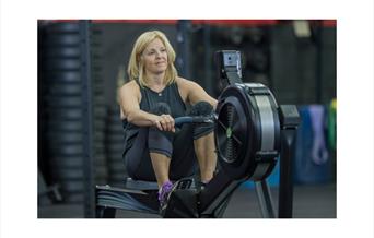 Women rowing on a rowing machine