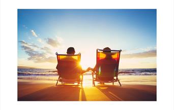 Two retired people in deckchairs