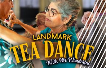 An older couple dancing, shot from a POV over the gentleman's shoulder