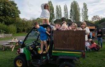 Children on small tractor in park - Photo by Herman Ng