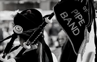 Man plying bagpipes