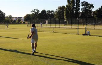 Tennis player playing on Bushy Park Tennis Courts