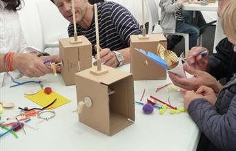 Fire the Inventor working with children on their creations.