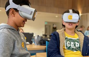 Two children with AR headsets on.