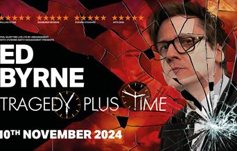 Poster for Ed Byrne: Tragedy Plus Time. Ed Byrne is smartly dressed in a suit with a red background behind him. There is the effect of smashed glass o