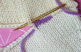 Knitted garment being sewn up