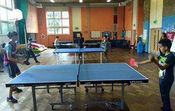 Two kids playing table tennis