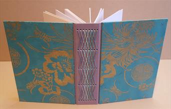 Pink and blue book with stitching