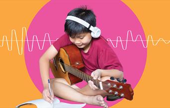 An child playing an electric guitar in an image that has been edited to incorporate digital soundwaves and an orange and pink backdrop