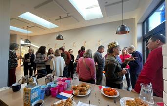 Students practising their French conversation over coffee and croissants