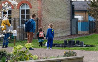 An adult and two children stand in the Orleans House Gallery grounds.