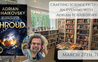 Picture of Adrian Tchaikovsky's latest book shroud in front of picture of the bookshop