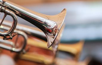 A close-up image of a gold trumpet