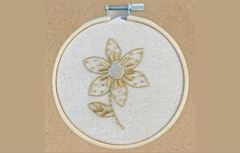 Flower stitched with goldwork