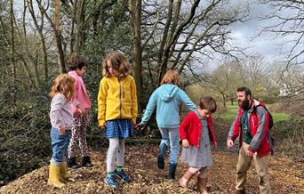Children on pile of wood chips