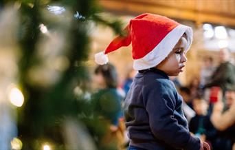 toddler in santa hat at bach to baby concert