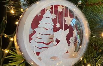 Papercut bauble with dog and stars