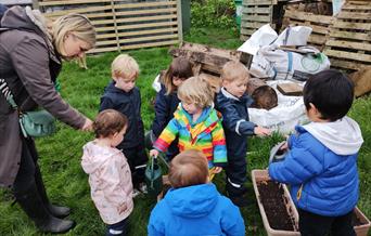 Children and adults at a community growing session