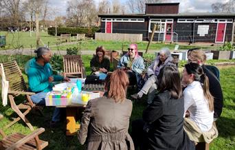 People sitting around a table in a garden