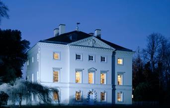 Picture of Marble Hill House at dusk with shadows of trees in the foreground
