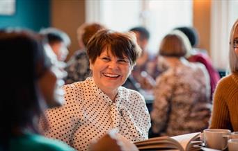 woman at table smiling