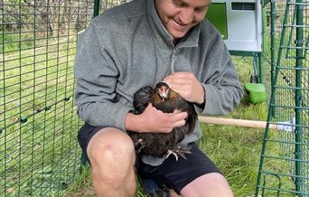 Senior gardener Pete with chicken
