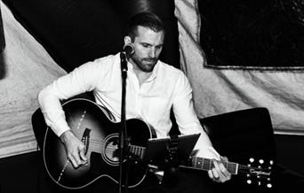 Phil Dexter playing the guitar
