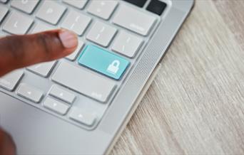 Finger hovering over a keyboard