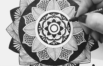 Hand drawing a mandala