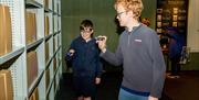 Two young boys looking through National Archive files