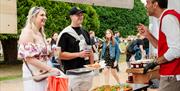 Hampton Court Food Festival - Food vendor talking to couple