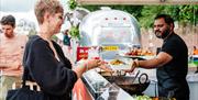 Hampton Court Food Festival - Food vendor handing over food