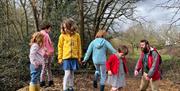 Children on pile of wood chips