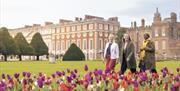 Three women walking in the gardens of Hampton Court Palace