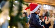 toddler in santa hat at bach to baby concert
