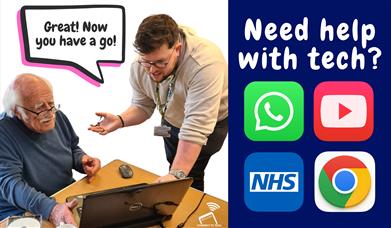 Picture in 2 halves. On left a standing digital trainer supports an older gentleman with glasses who is using a laptop. A speech bubble above them say