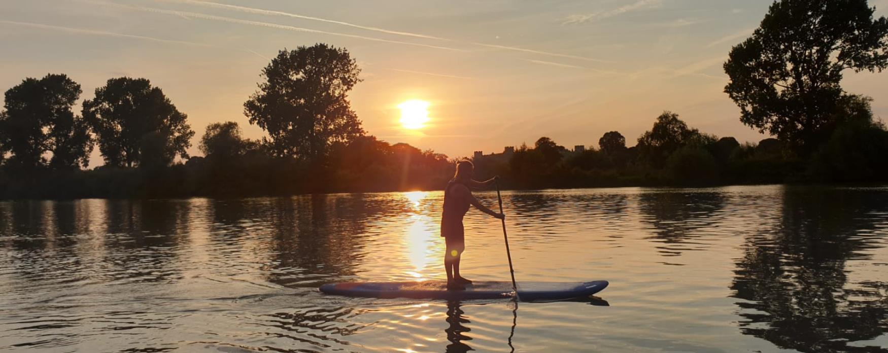 Girl paddleboards on the River Thames, Richmond upon Thames