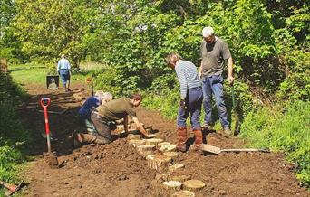 Volunteers building steps on the common out of Robinia wood