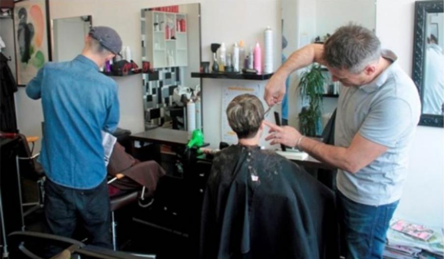 A picture of Claudio cutting hair