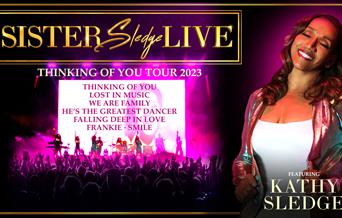 Poster for Sister Sledge LIVE Thinking of You Tour 2023, featuring Kathy Sledge. Kathy stands in the foreground, smiling and dressed in a sparkling pi
