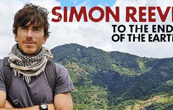 Artwork for 'Simon Reeve - To The Ends Of The Earth'. Simon is visible from chest up, dressed for hiking and with his arms crossed. He is against a ba