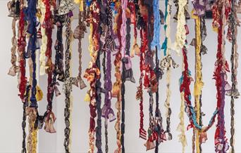 Hanging sculpture of colourful textile garland