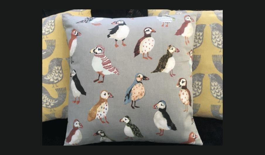 Machine sewn cushion with bird fabric
