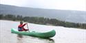 a man padling in a canoe at Nisser in Vrådal