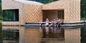 family sitting outside Soria Moria with their feet in the water