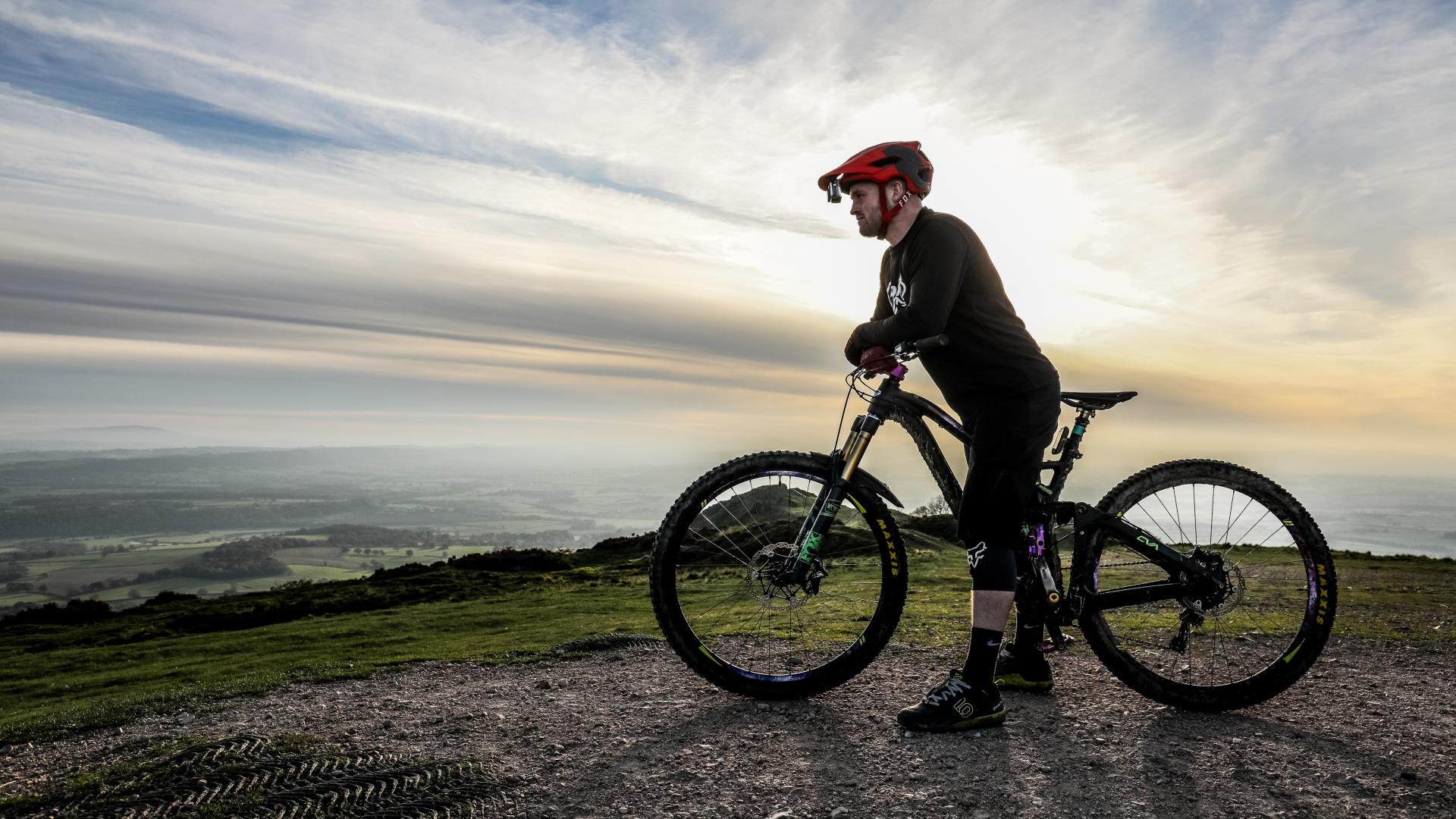 cyclist on bike looking out over the countryside