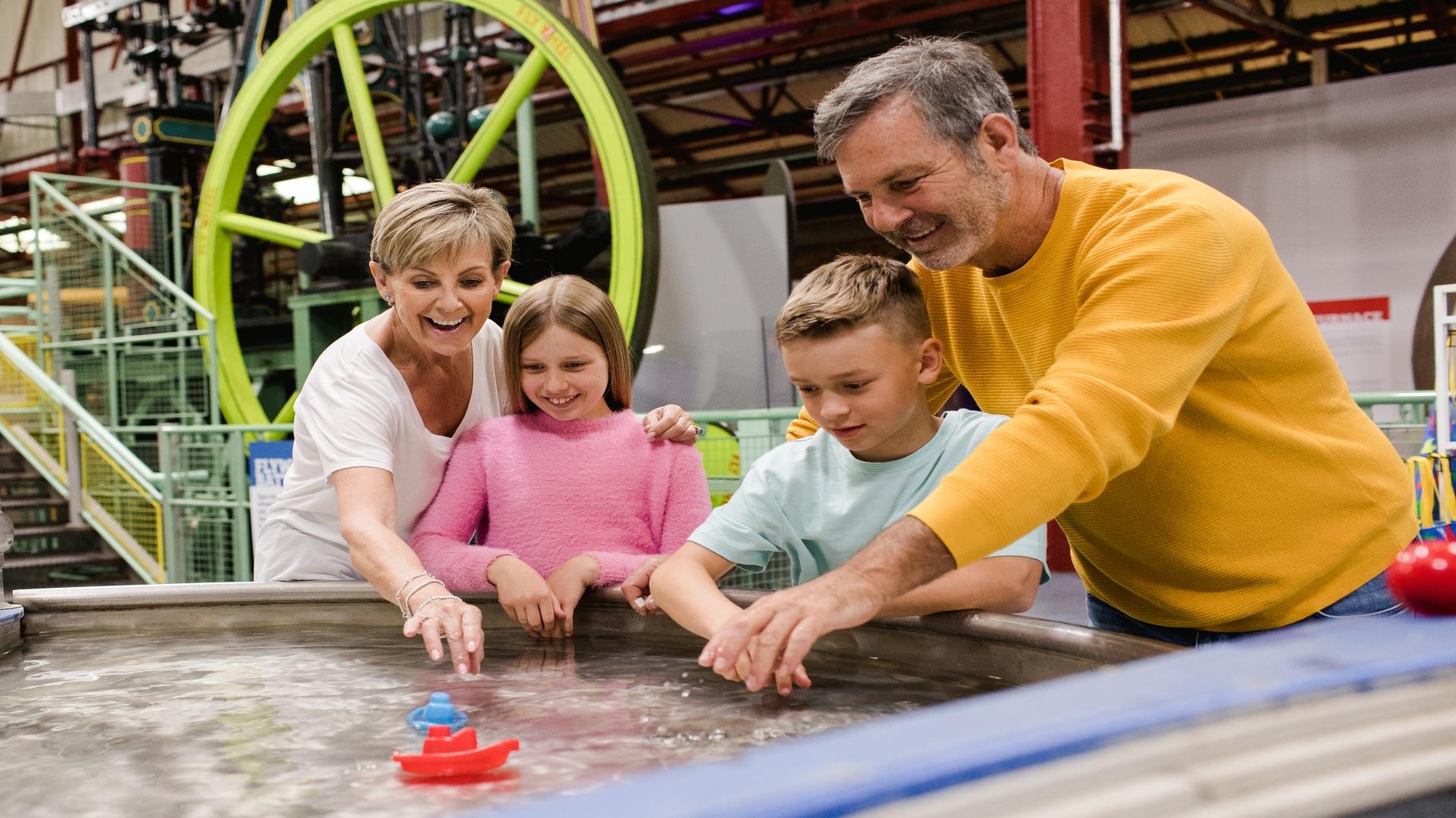 Family exploring an exhibit at Enginuity Museum