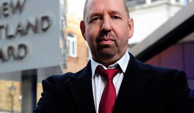 A photo of Alfie Moore outside Scotland Yard
