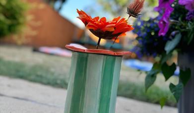 Hand-buillt and decorate a ceramic vase and flower frog